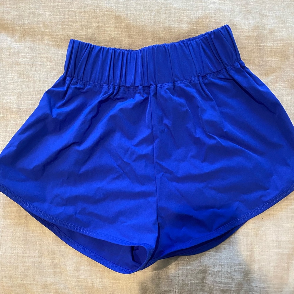 small bright blue high rise halara dolphin shorts